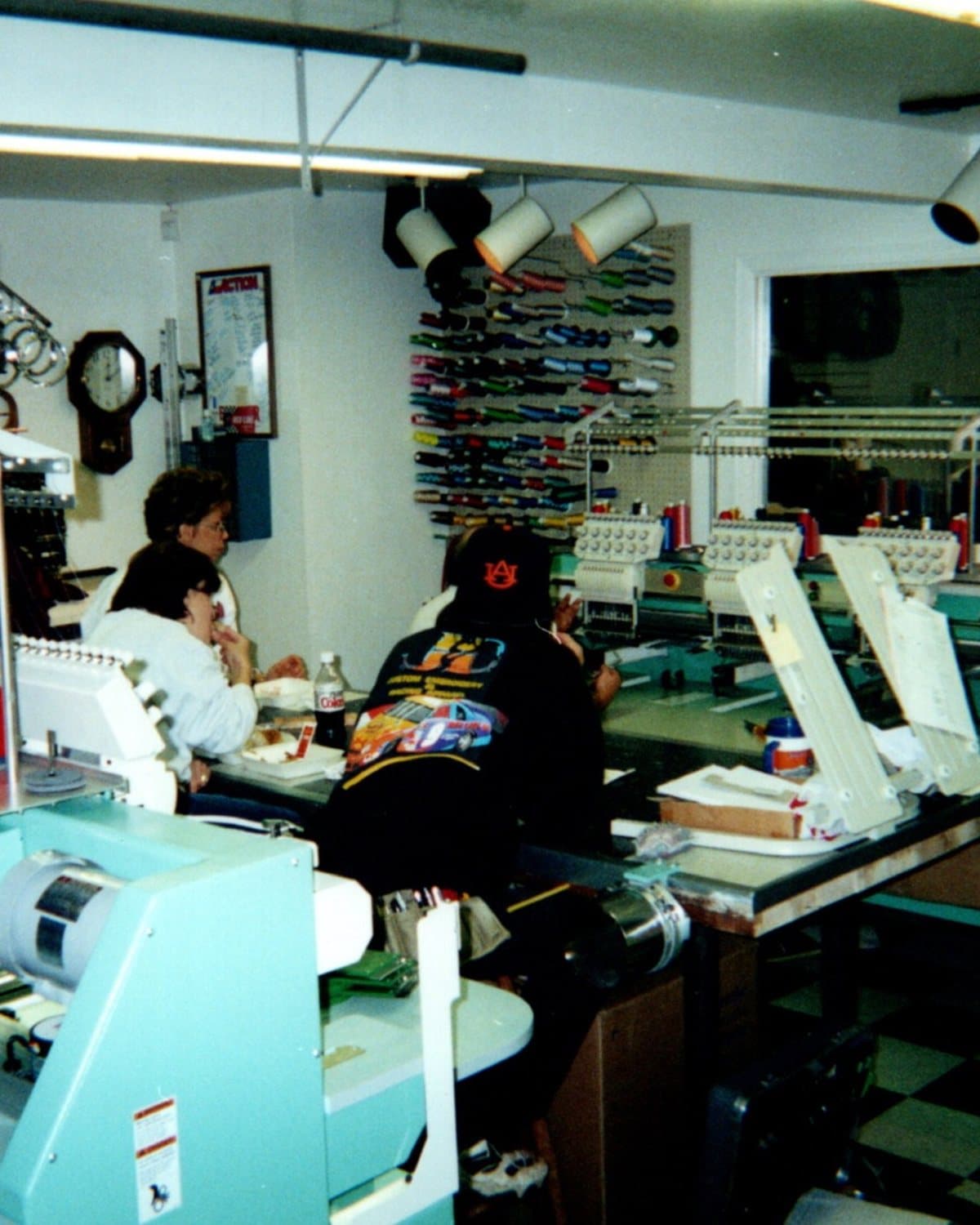 Dennis and Janet Davis working at the original J&D Custom Embroidery shop floor in Martinez, CA — vintage photo from the 1990s